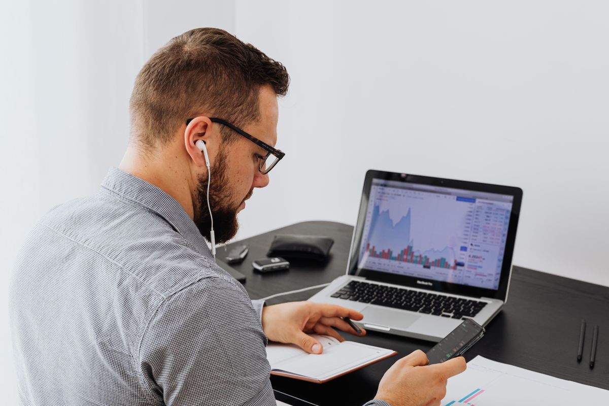 A professional working at a laptop, side profile