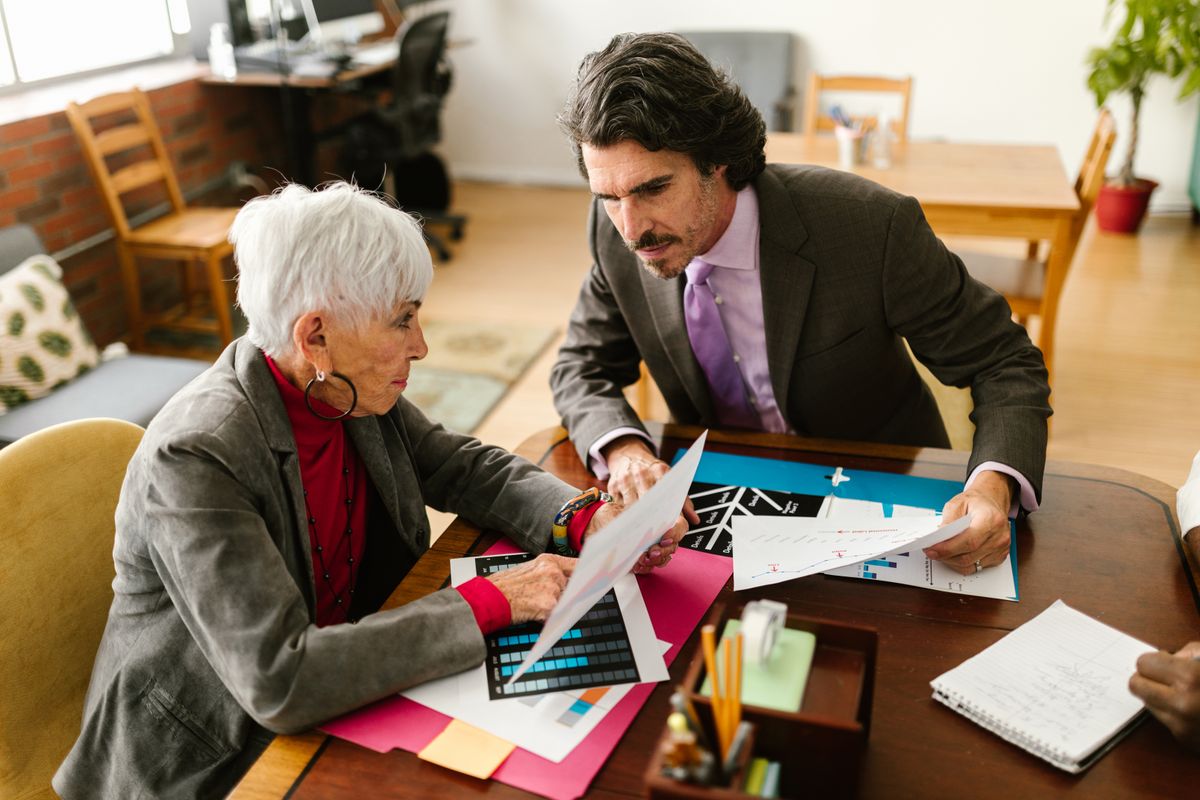 Colleagues reviewing compensation charts at a table