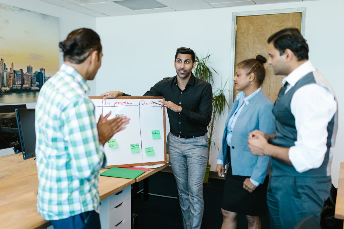 Colleagues reviewing a document during a presentation